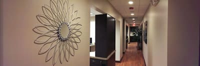 Sunburst mirror decor in the hallway of TruCare Dentistry's Bloomingdale office