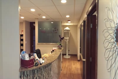 Inside the TruCare Dentistry office in Bloomingdale, IL - reception desk, hallway and waiting room
